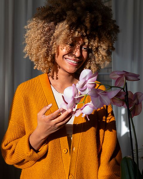 close-up-woman-decorating-her-home-with-orchids.jpg